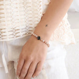 sunstone bead detail on soleil brilliance bracelet in gold, close-up on model