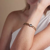 video showing details of lunar curb link bracelet in gold on model