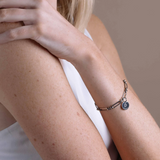 model wearing solar link bracelet in stainless steel on wrist, close-up