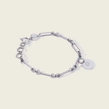 engravable 0.5 inch round pendant on solar link bracelet, close-up
